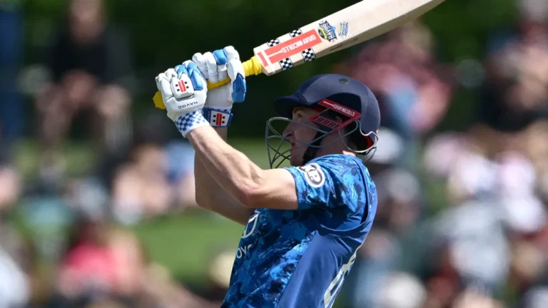 Harry Brook biography: Harry Brook batting in the England blue ODI kit, raising his bat during the NZ vs ENG 1st ODI record innings