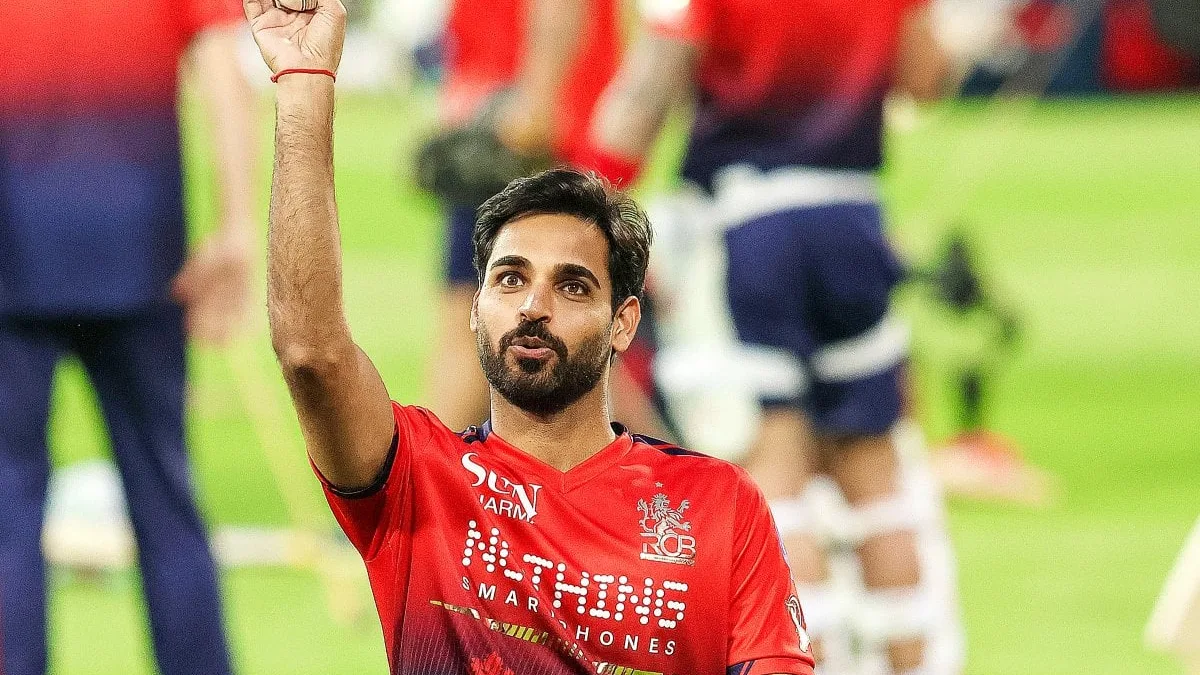 bhuvneshwar kumar biography: Bhuvneshwar Kumar holding the ball aloft after a wicket milestone