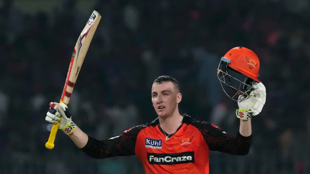 Harry Brook biography: Harry Brook raising his bat and helmet in Sunrisers Hyderabad colours after his maiden IPL century against Kolkata Knight Riders at Eden Gardens