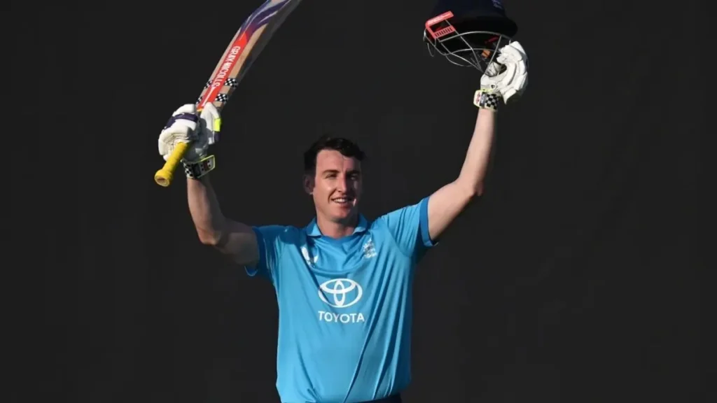Harry Brook biography: Harry Brook raising his bat and helmet after his record double century of 202 against Sri Lanka at Rawalpindi